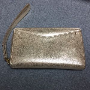 Fossil gold foil leather wristlet w/phone slot.